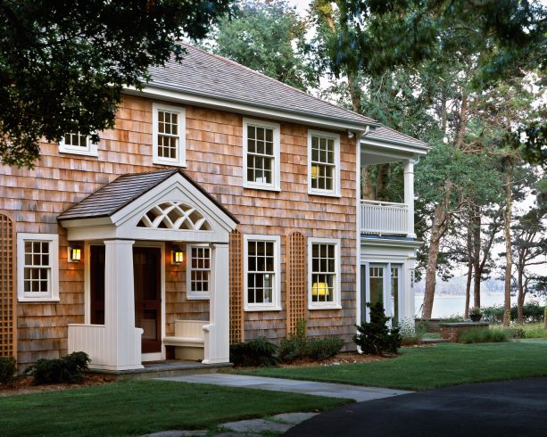 decorative front door portico with an arched lattice and built-in benches in the columns