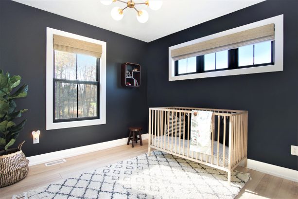 gender-neutral scandinavian nursery with black windows, roman shade, and white trim