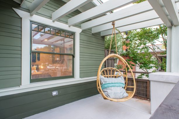 installing a pergola and hanging a swing on the concrete front porch