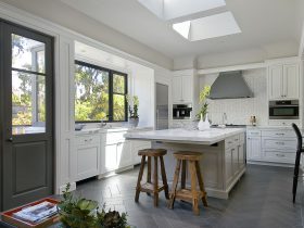 italian volcanic basalt floor tile in gray with white cabinets to create a transitional look