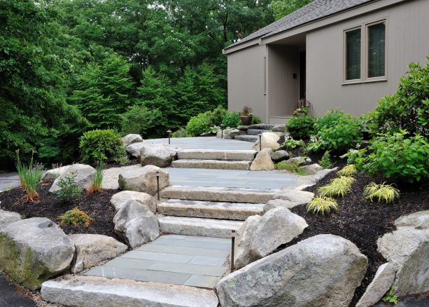 japanese style grassless front yard landscaping with stone and concrete steps and boulder borders