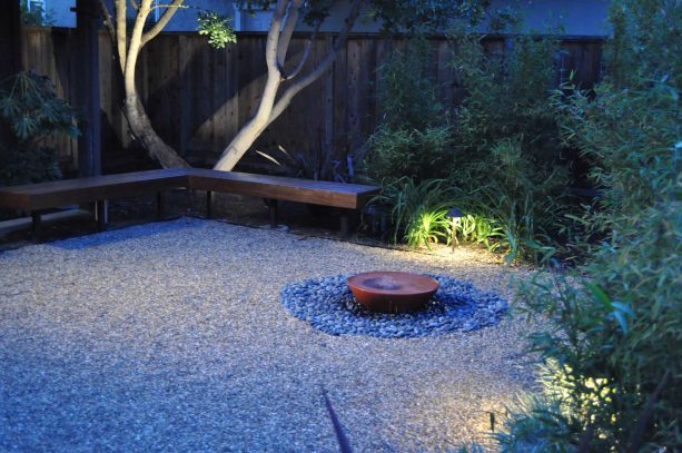 plant-free gravel courtyard landscaping with closed corner fence as a screen