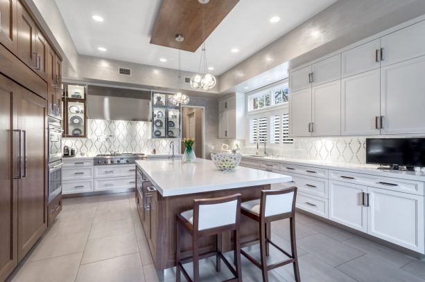 porcelain floor tile in light gray to create a luxurious look in a transitional kitchen with white cabinets