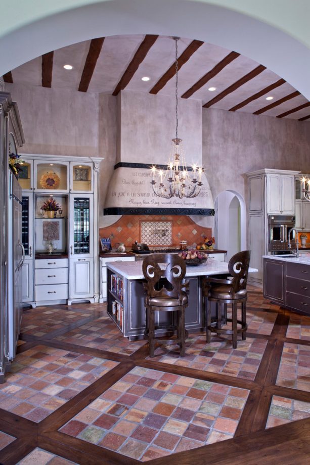 reclaimed terracotta floor tile trimmed by hickory with white cabinets to enhance a french country look