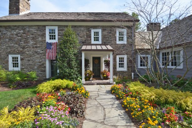 simple portico with a metal roof to cover a dark single front door