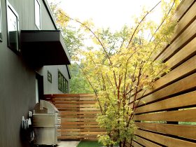 the idea of contemporary landscaping with polished corner fences is made of meranti wood