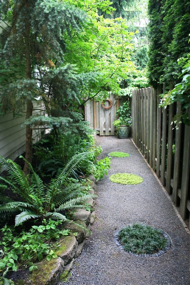 the idea of traditional side yard landscaping with a tall corner fence