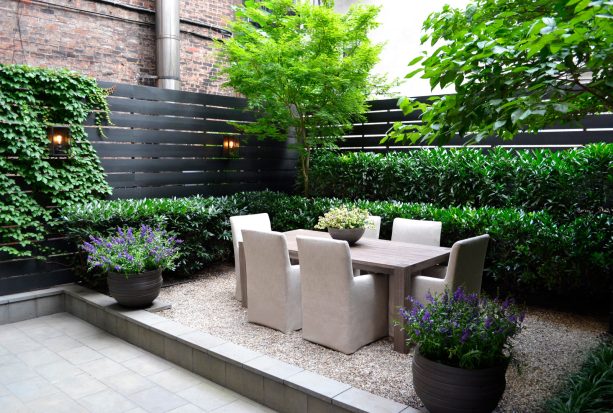 the idea of transitional landscaping with a dark stained horizontal slatted corner fence