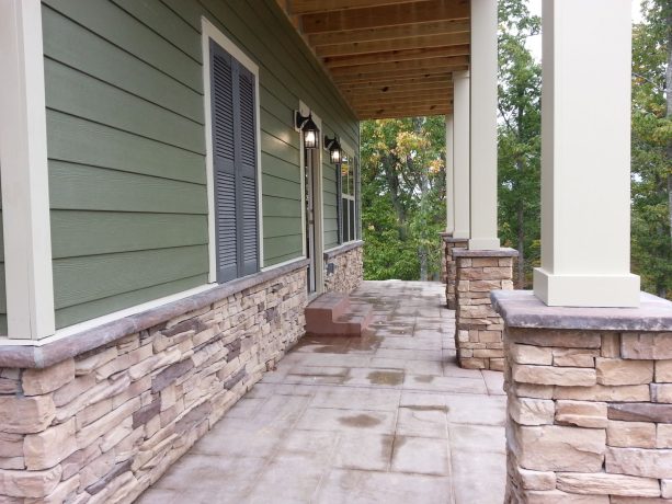the idea of using stamped concrete in the front porch to match the stone element