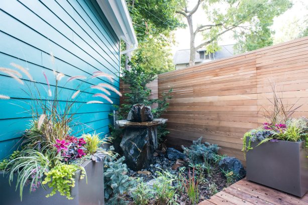 tight slatted corner fence to conceal a hidden oasis in a side yard