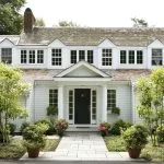 traditionally styled portico painted in benjamin moore - brilliant white with tuscan columns and black front door