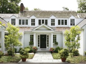 traditionally styled portico painted in benjamin moore - brilliant white with tuscan columns and black front door