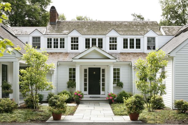 traditionally styled portico painted in benjamin moore - brilliant white with tuscan columns and black front door