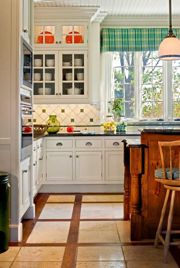 travertine floor tile with hardwood lining to contrast and complement the white cabinets