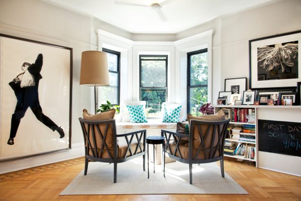 victorian family room with black double hung windows, white trim, and beige wall