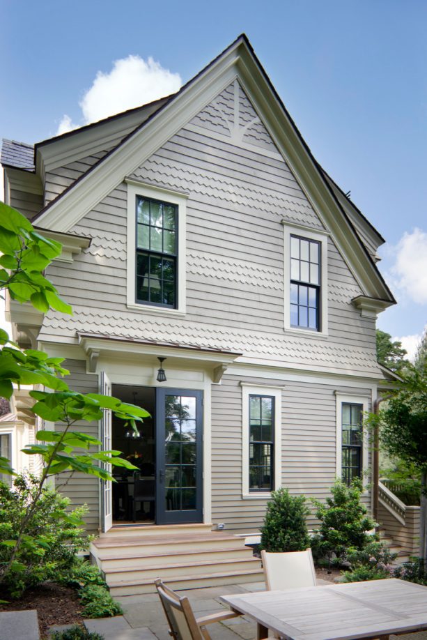 victorian house with windows painted in black panther, off-white trim painted in carrington beige, and soft brown siding painted in racoon hollow