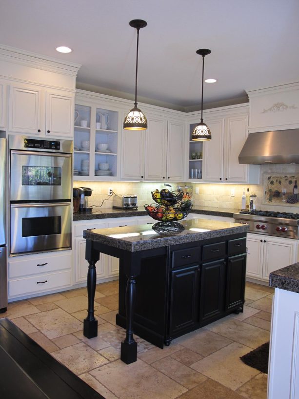 walnut travertine floor tile in versailles pattern paired with white cabinets to embrace a conventional look