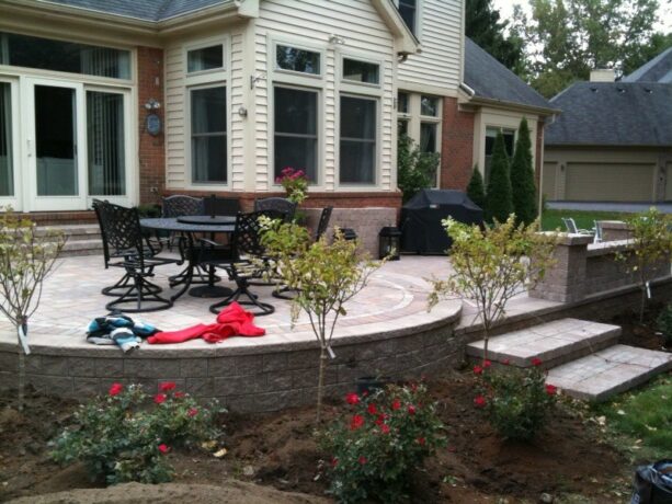 a traditional raised patio made of pavers and edged with bricks