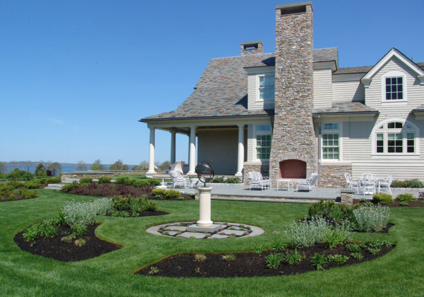 bluestone full sun raised patio with an outdoor fireplace