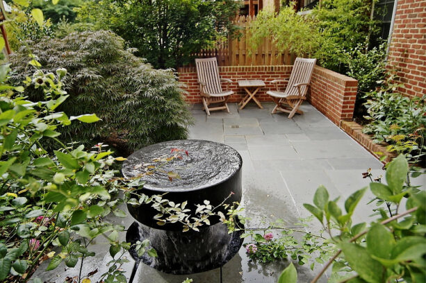 brick townhouse backyard with a water feature