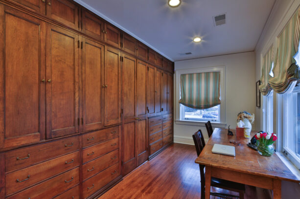 built-in wood cabinets as an office accent wall