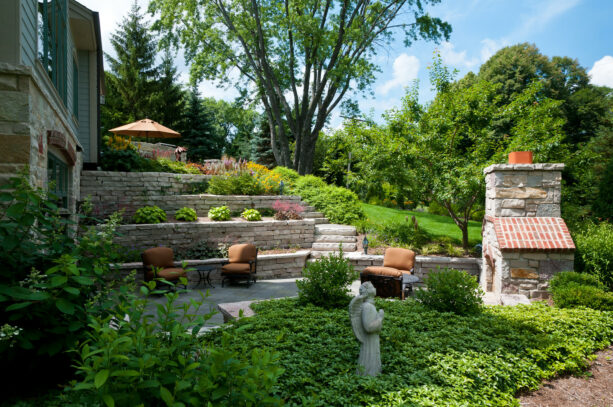 classic stone sunken patio with a tiered retaining wall