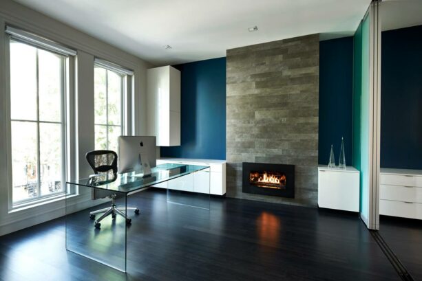 dark blue accent wall with a fireplace surrounded by a porcelain tile in a home office