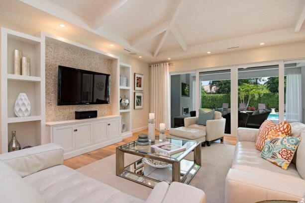 glass mosaic tile accent wall behind the tv as a part of custom cabinetry