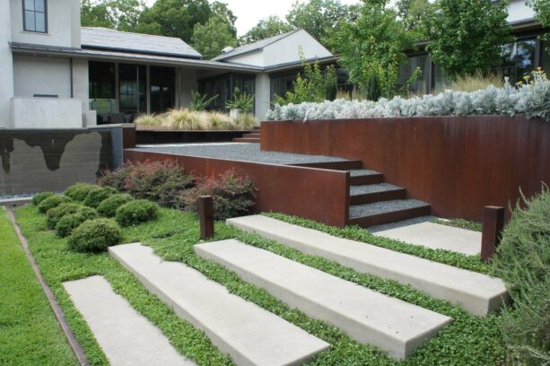 gravel landscaping with corten steel tiered retaining wall
