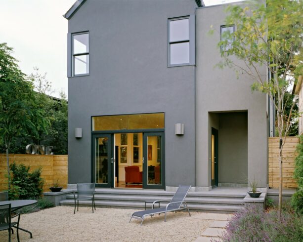 gravel patio with seating in a townhouse backyard