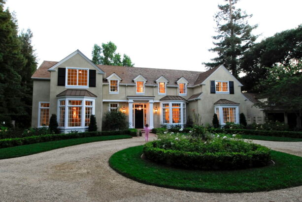 greeneries and lawn landscaping in the center of a circular driveway