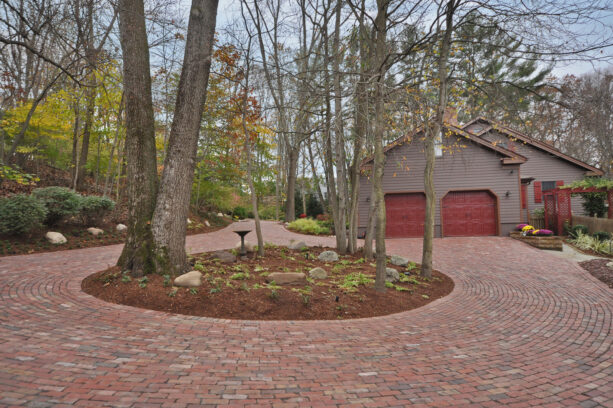 planting trees as a center landscaping of a red brick paver circular driveway