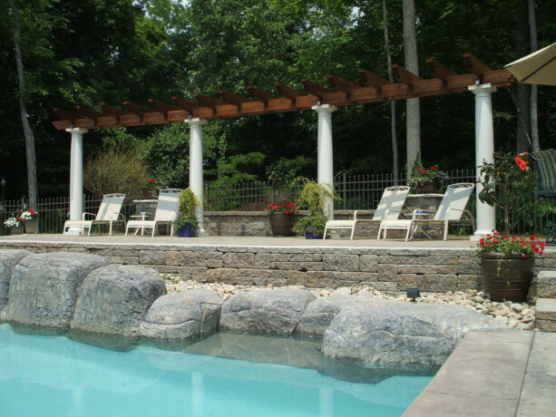 raised patio is created alongside the pool
