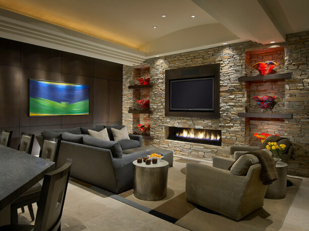 rift cut oak panel behind a tv in a stone accent wall