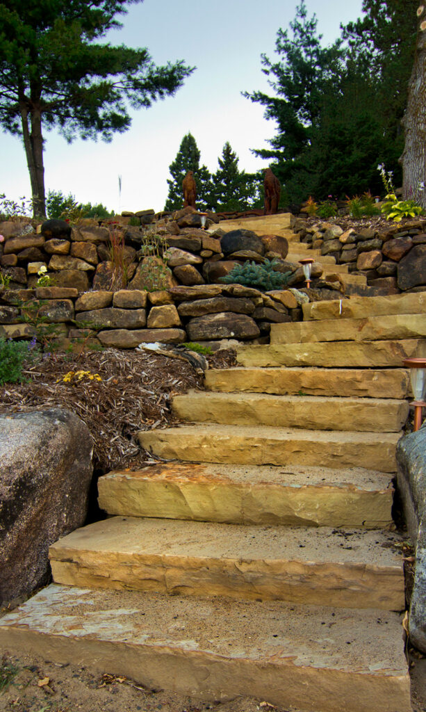 rock tiered retaining wall to create a rustic look