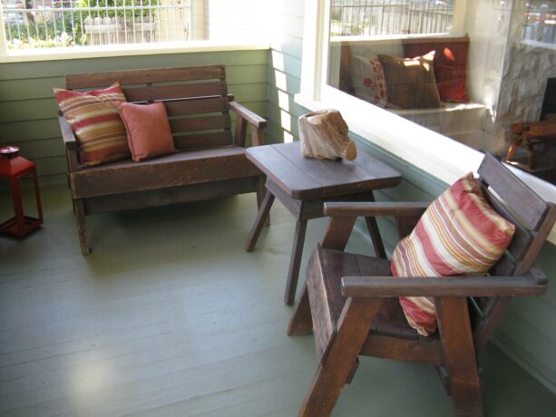 rustic wood furniture seating in a traditional front porch