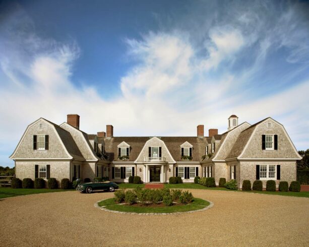 small shrubs are landscaped in a gravel circular driveway