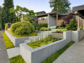 smooth surface poured concrete tiered retaining wall with a staircase in the middle