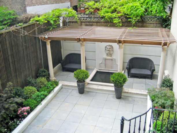 timeless townhouse backyard patio with concrete-edged planter beds