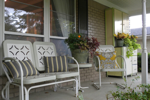 vintage chic glider and a seating chair on an eclectic porch