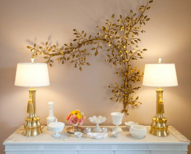 vintage gold painted metal branch with lamps in an accent wall