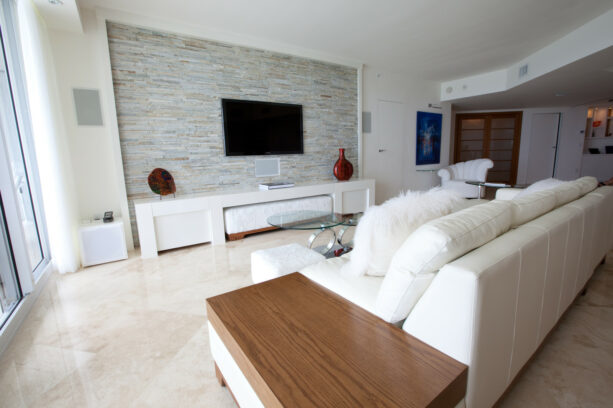walker zanger tiled a tv accent wall in a white living room
