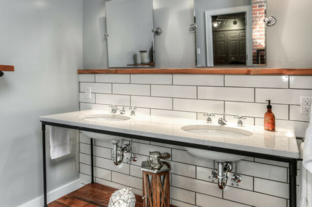 wood bathroom trim to separate the white tiles and the gray wall