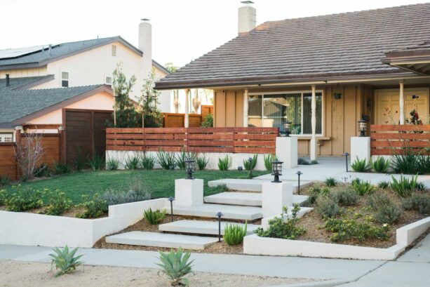 a pair of concrete walls and a wood fence for a privacy front yard