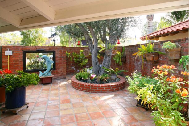 brick wall with mounted pots in a mediterranean patio
