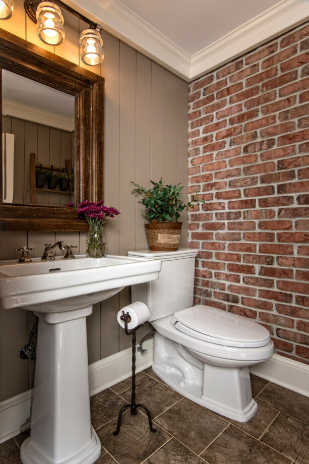 brownish gray vertical shiplap siding paired with a brick wall