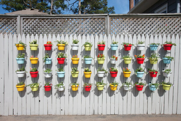 creating a focal point by using a fence and colorful pots as a patio wall