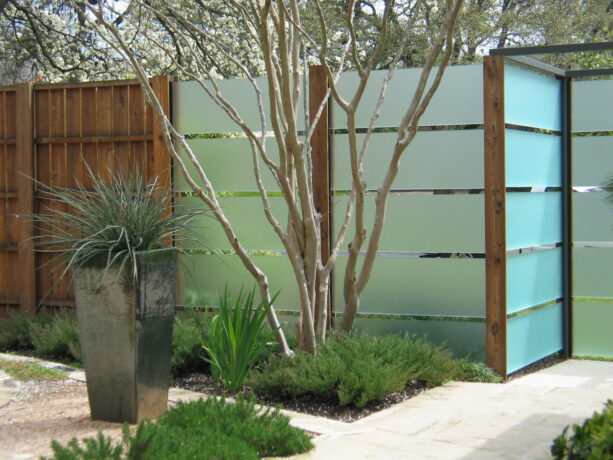 enclosing your front yard for privacy with thick panels of frosted glass