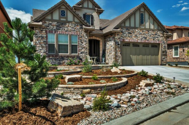 four planting beds are made of semi-circular retaining walls in low-maintenance hillside landscaping