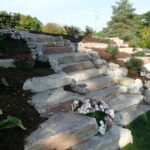 hillside landscaping with stone steps and low-maintenance plants